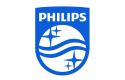 The image is the logo of Philips. It features the word "PHILIPS" in bold, uppercase white letters within a blue rectangle at the top. Below the text, there is a shield-shaped emblem also in blue. Inside the shield, there are three wavy lines and four stars, arranged in a pattern that represents the company's legacy in electronics and innovation. The overall design is clean, modern, and instantly recognisable.